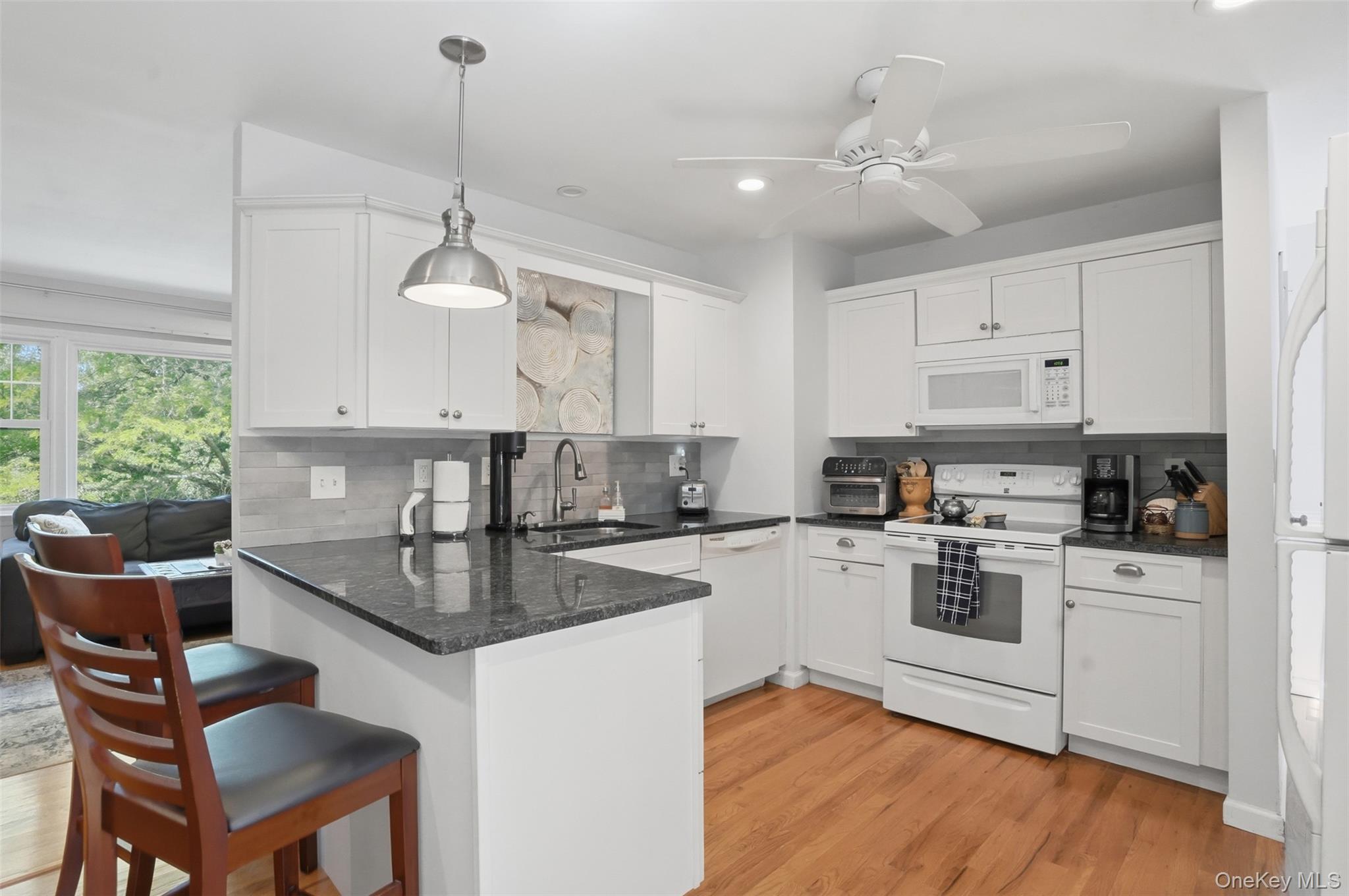 30 Olympus Road Highland Mills, NY 10930 - Photo 7 of 30 Granite counters, breakfast bar and hardwood floors continue