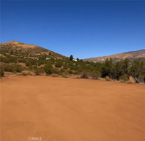 a view of mountain with sunset in background