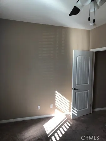 an empty room with wooden floor and windows in it