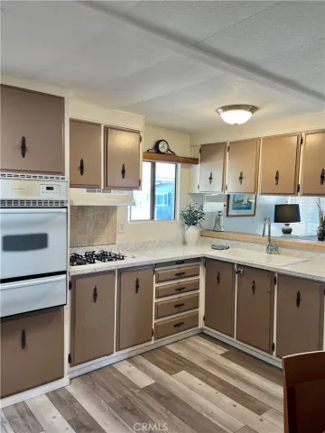 a kitchen with granite countertop a sink stainless steel appliances and cabinets