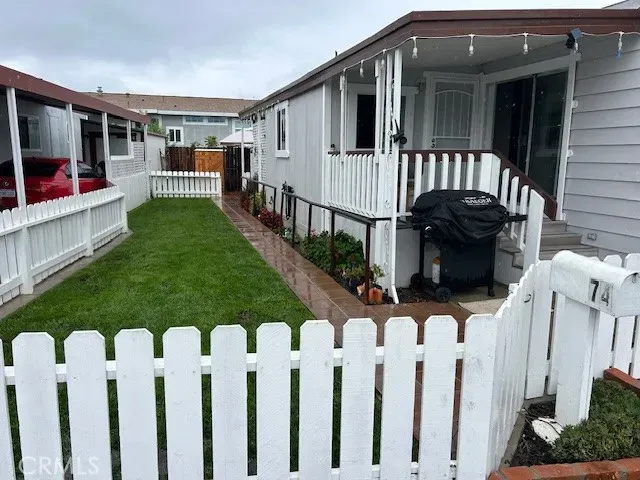 a view of a house with wooden fence