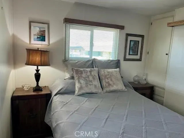a bedroom with a bed and a night stand