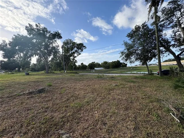 a view of outdoor space with green field and trees