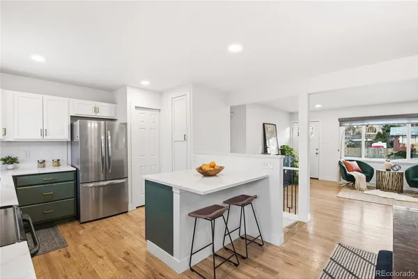 a kitchen with stainless steel appliances granite countertop a refrigerator and a stove top oven