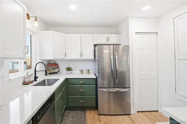 a kitchen with refrigerator a sink and cabinets