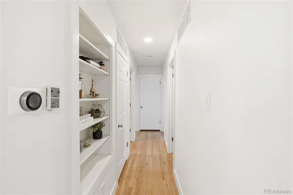 a view of a hallway with wooden floor
