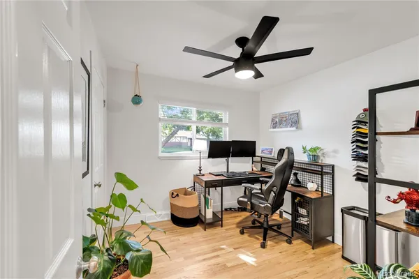 a view of a workspace with furniture and a window