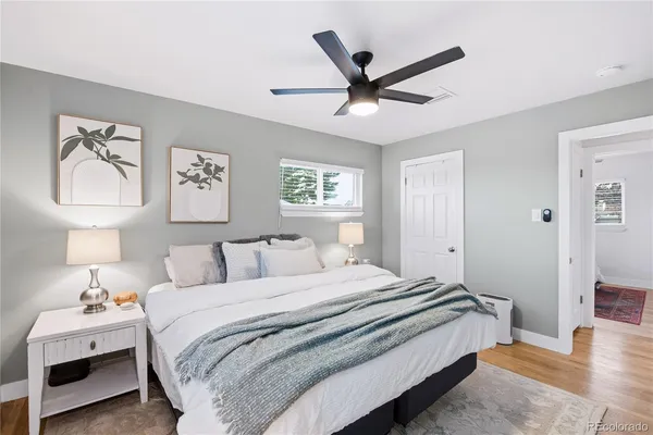 a bedroom with a large bed and a chandelier
