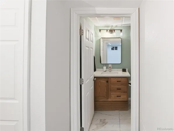 a bathroom with a sink a mirror and a vanity