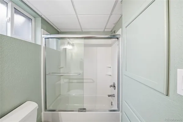 a bathroom with a glass shower door