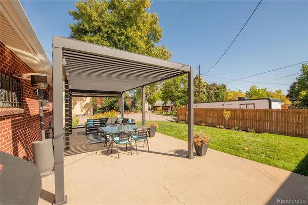 a view of a patio with a table chairs and backyard