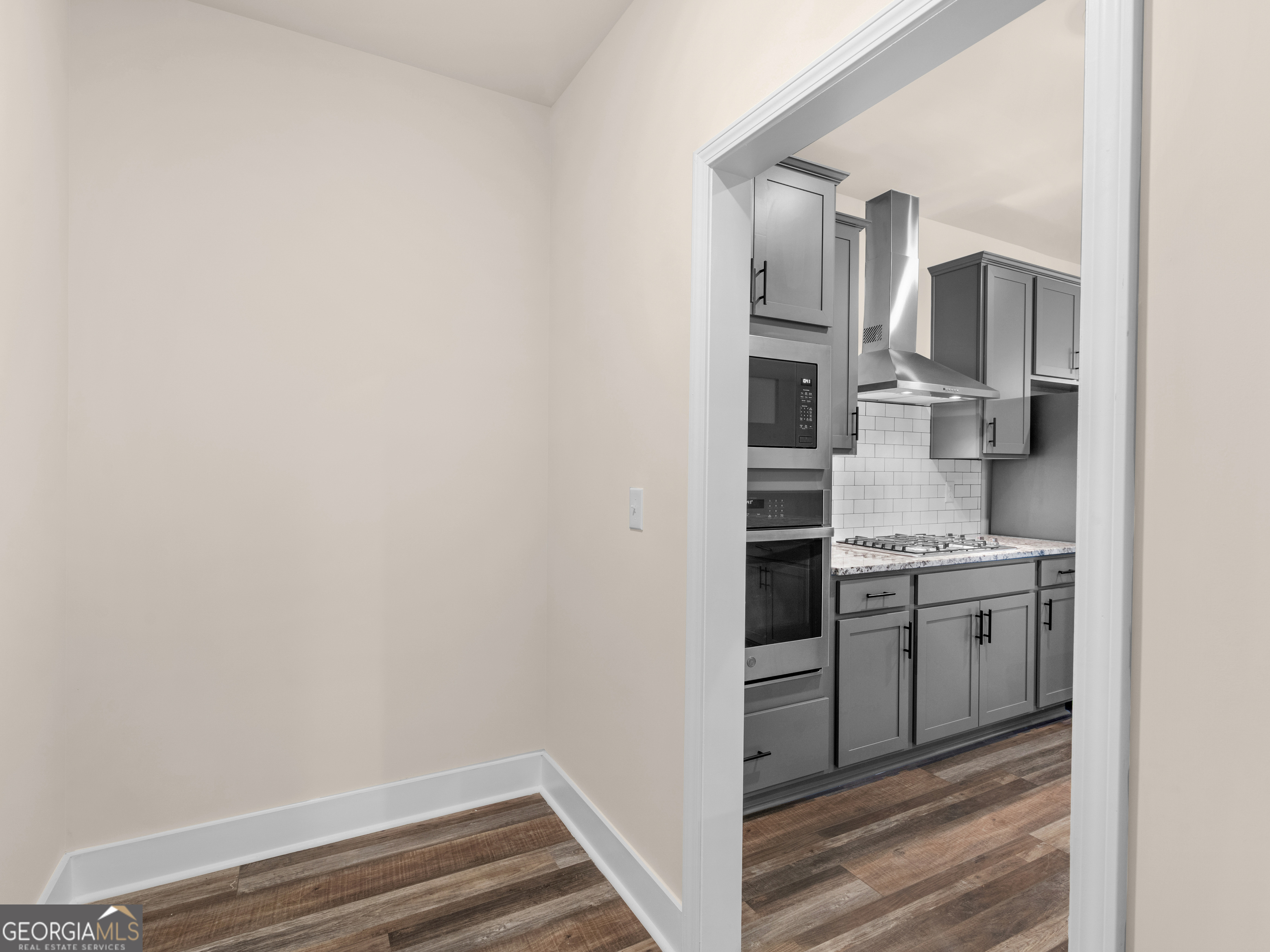 160 Loyd Road Mansfield, GA 30056 - Photo 30 of 53 a kitchen with cabinets and stainless steel appliances