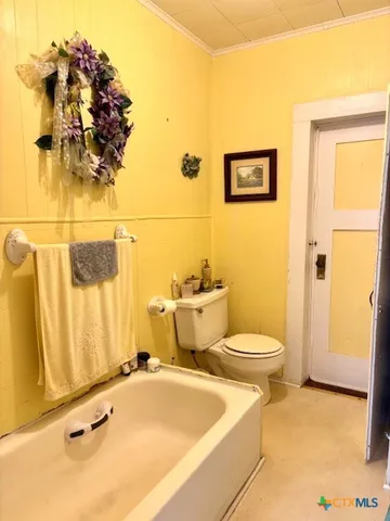 a bathroom with a toilet sink and shower