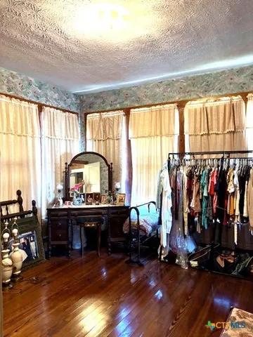 a view of a room with gym equipment and windows