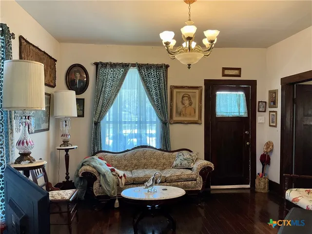 a dining room with furniture and a chandelier