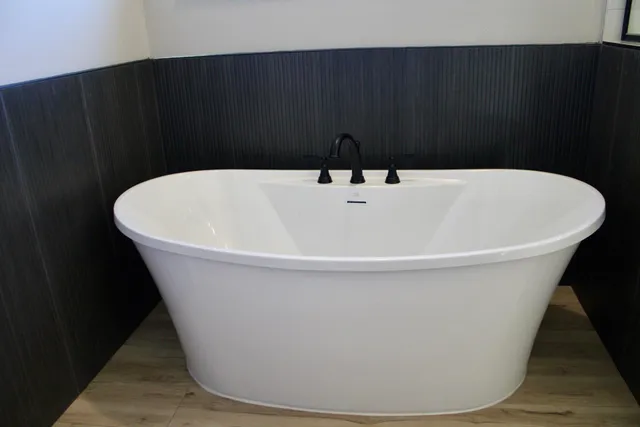a white bath tub sitting in a bathroom