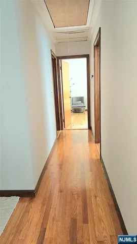 a view of a room with wooden floor and a window