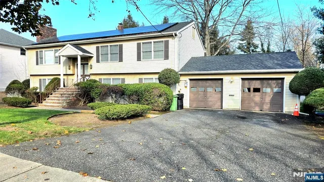 a front view of a house with a garden and porch