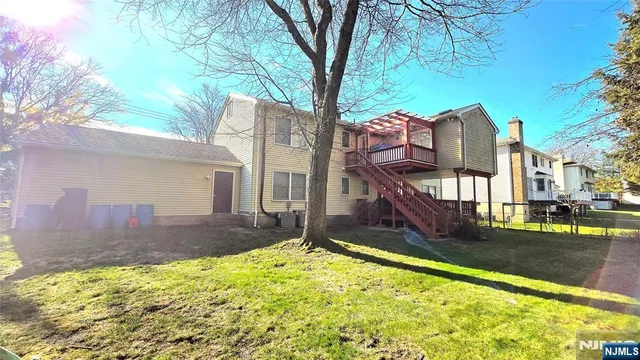a view of a house with a yard and furniture