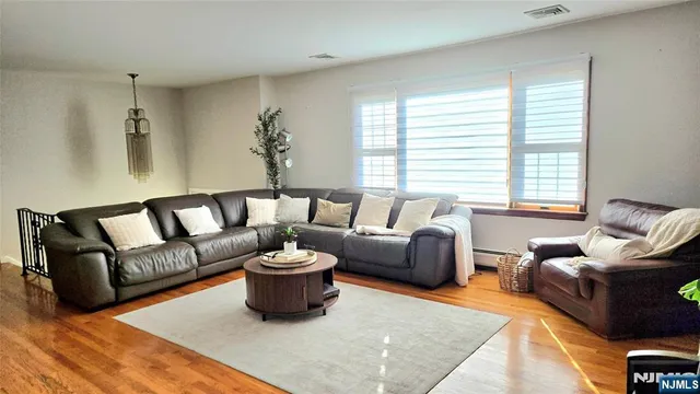 a living room with furniture ceiling fan and a window