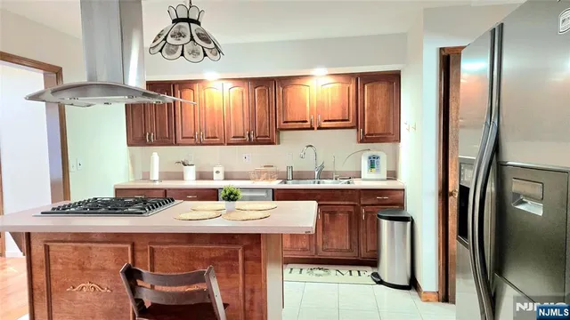 a kitchen with a refrigerator and a stove top oven