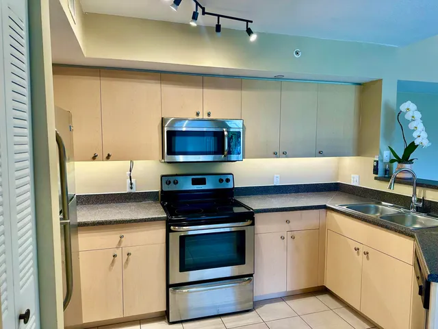 a kitchen with granite countertop a stove and a sink