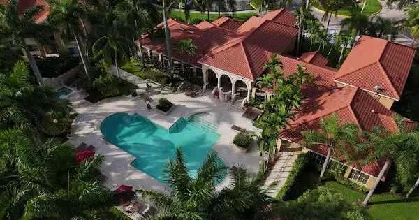 an aerial view of a house with garden space and sitting area