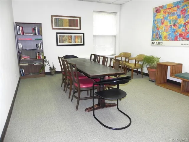 a dining room with furniture and window