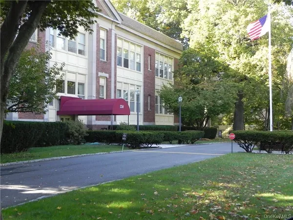 a view of a yard in front of a brick building