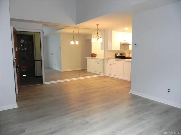 a view of a kitchen with a refrigerator and a sink