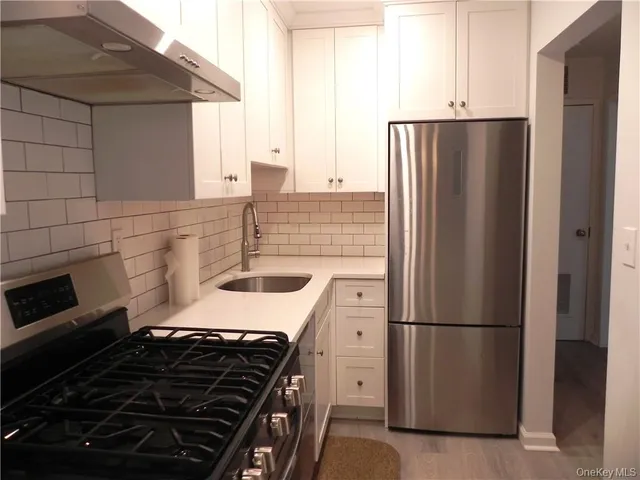 a kitchen with a refrigerator and a sink