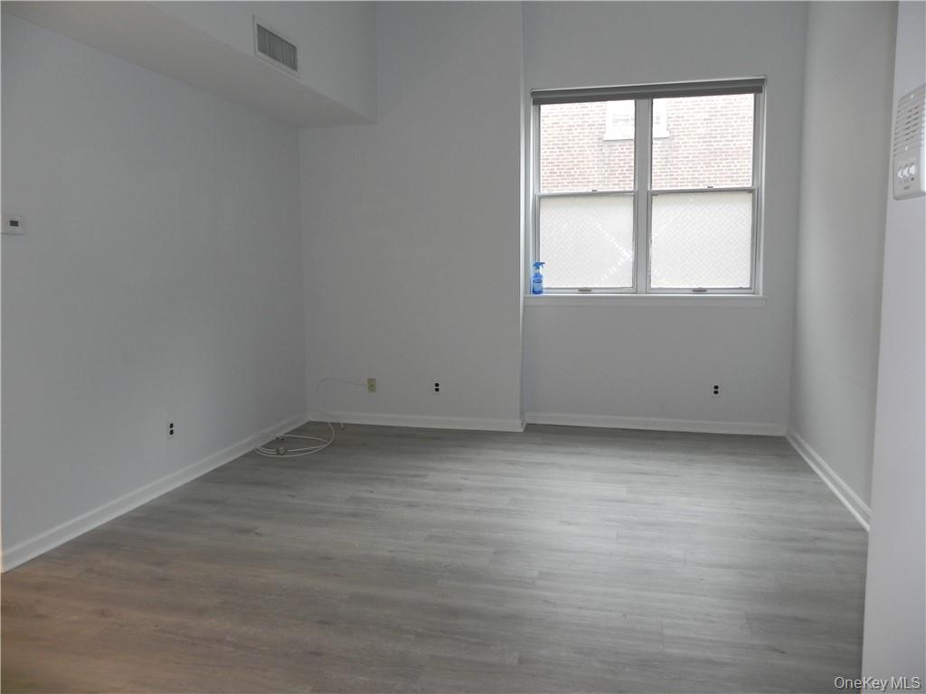 1250 North Avenue, Unit 209 New Rochelle, NY 10804 - Photo 9 of 26 an empty room with a window