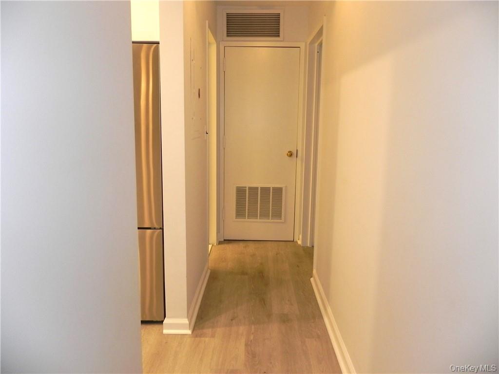 1250 North Avenue, Unit 209 New Rochelle, NY 10804 - Photo 10 of 26 a view of a hallway with wooden floor