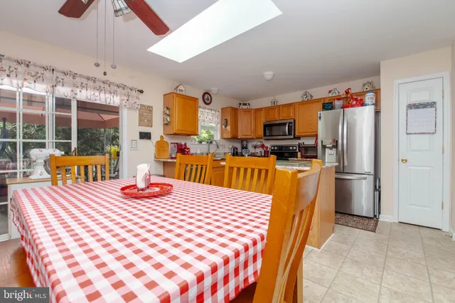 a bedroom with a large bed and a flat tv screen on dresser