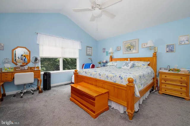 a bedroom with a bed and a flat tv screen on dresser