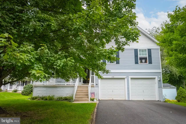 a front view of a house with a yard and a garage