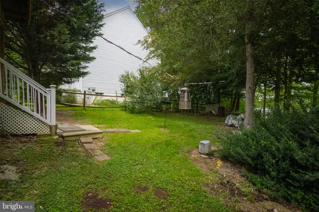 an aerial view of a house with a yard and garden