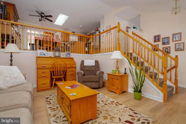 a living room with furniture and a book shelf