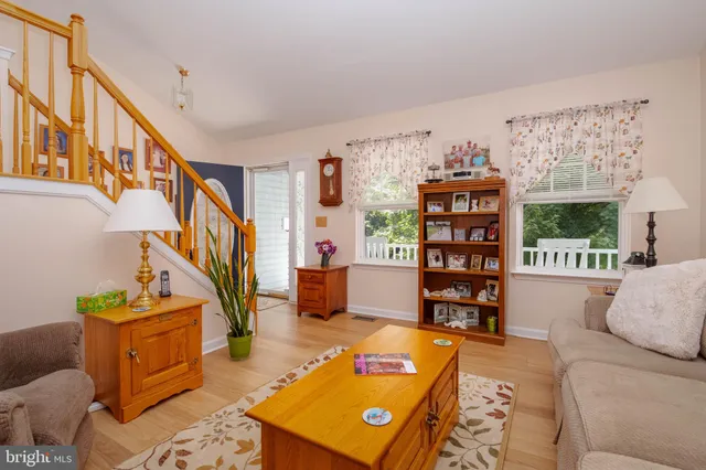 a kitchen with stainless steel appliances kitchen island granite countertop a refrigerator a stove a sink dishwasher with a dining table and chairs