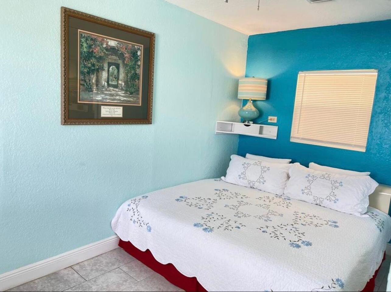 2776 Seminole Road Palm Springs, FL 33406 - Photo 11 of 24 a bedroom with a bed and a painting on the wall