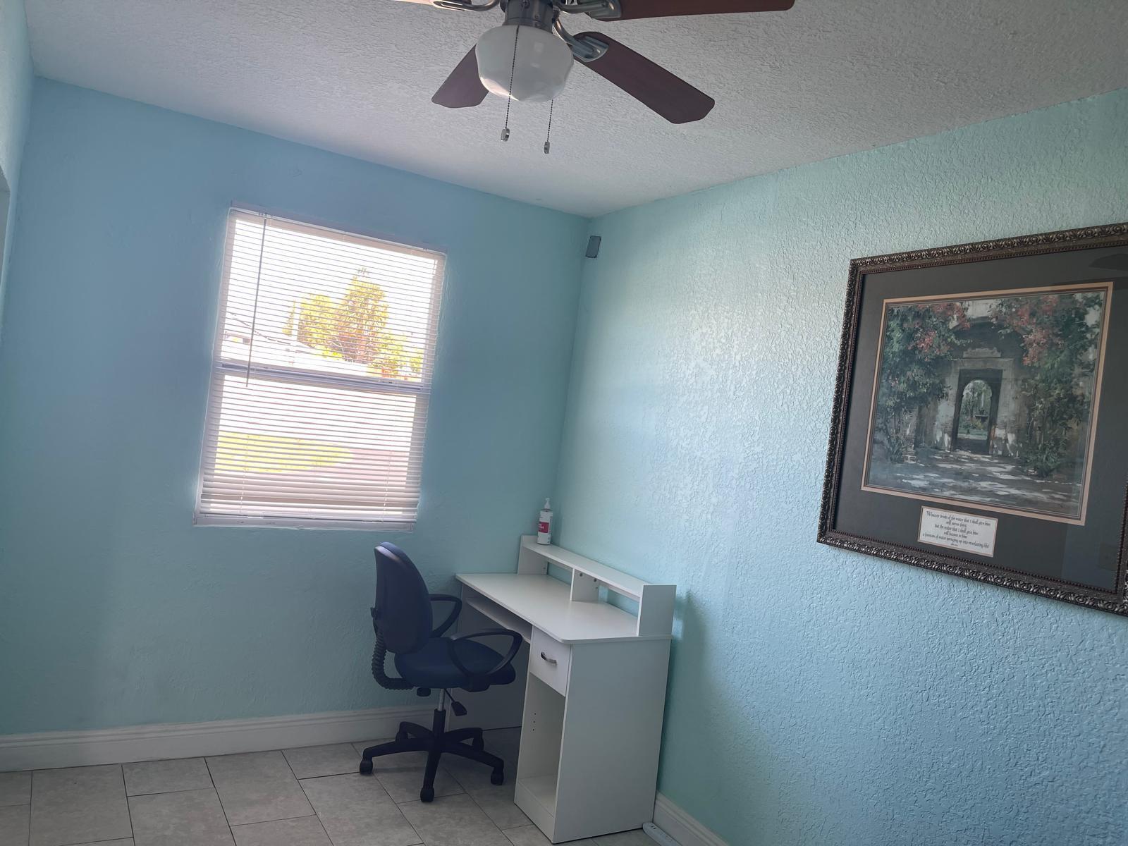 2776 Seminole Road Palm Springs, FL 33406 - Photo 12 of 24 a view of a workspace with furniture and a window