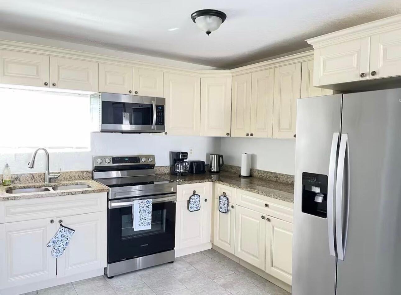 2776 Seminole Road Palm Springs, FL 33406 - Photo 13 of 24 a kitchen with stainless steel appliances granite countertop a refrigerator stove a sink and dishwasher