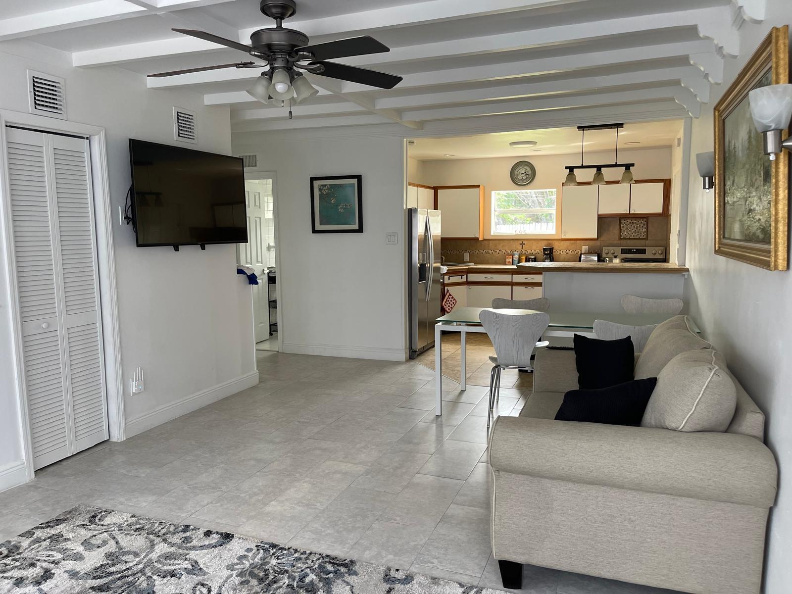 2776 Seminole Road Palm Springs, FL 33406 - Photo 15 of 24 a living room with furniture and a flat screen tv