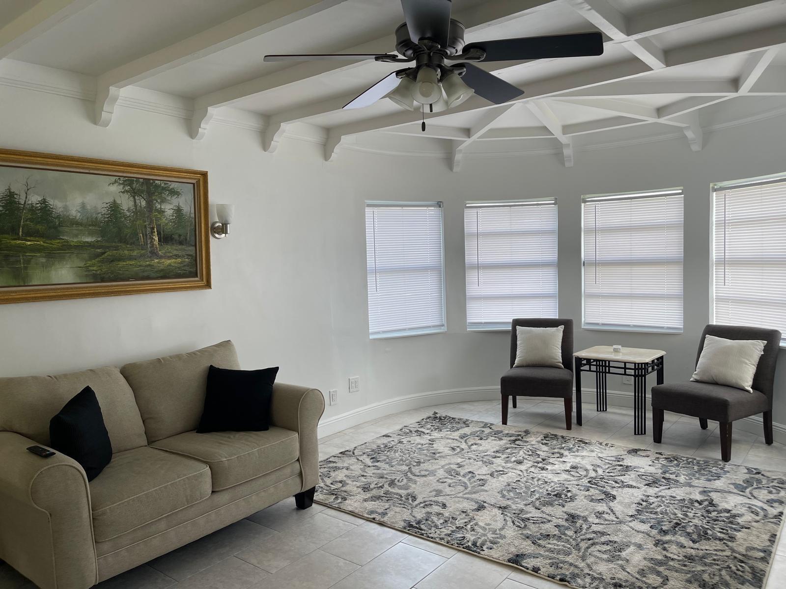 2776 Seminole Road Palm Springs, FL 33406 - Photo 16 of 24 a living room with furniture a flat screen tv and a window
