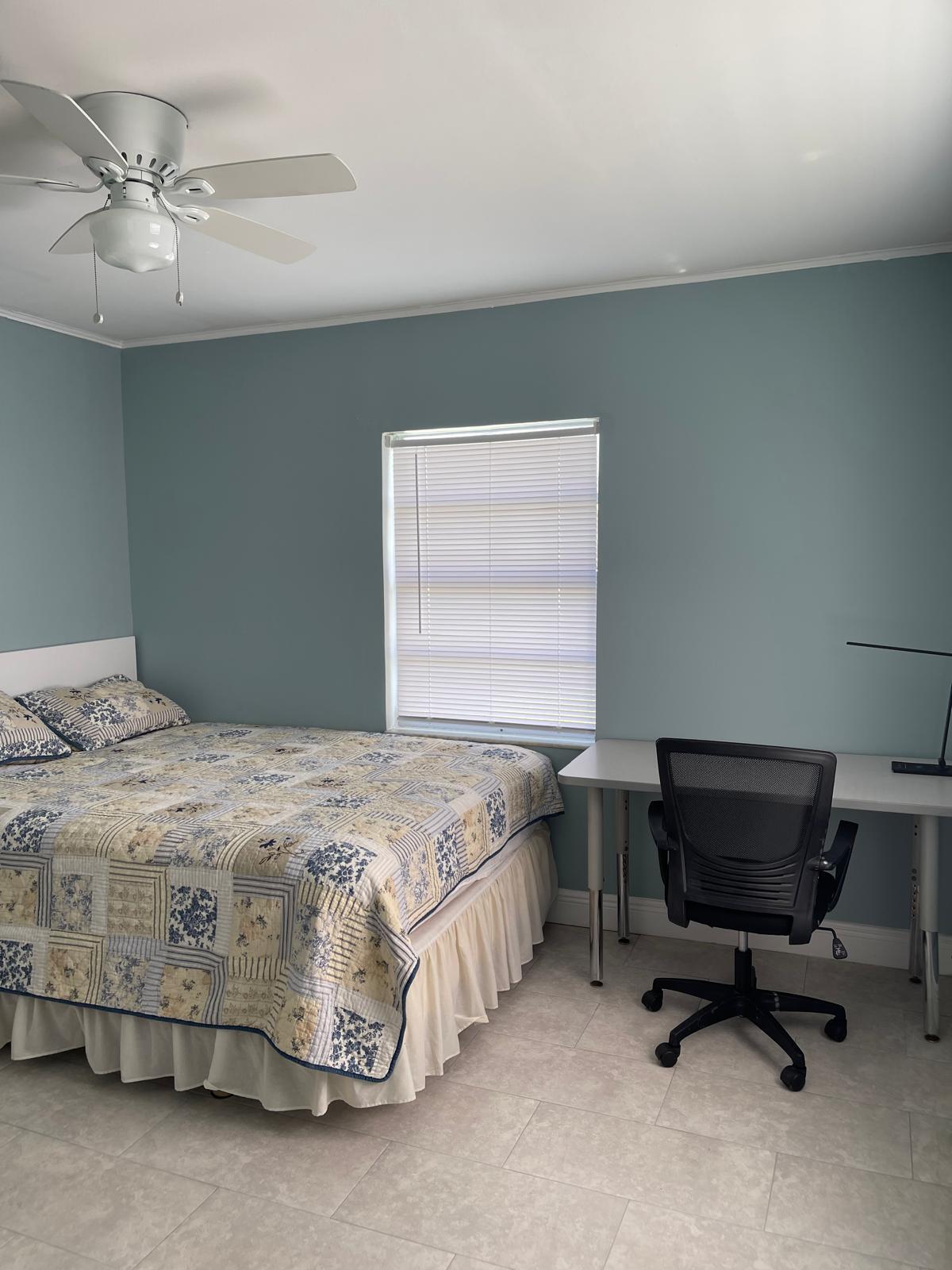 2776 Seminole Road Palm Springs, FL 33406 - Photo 21 of 24 a bedroom with a bed and a chair