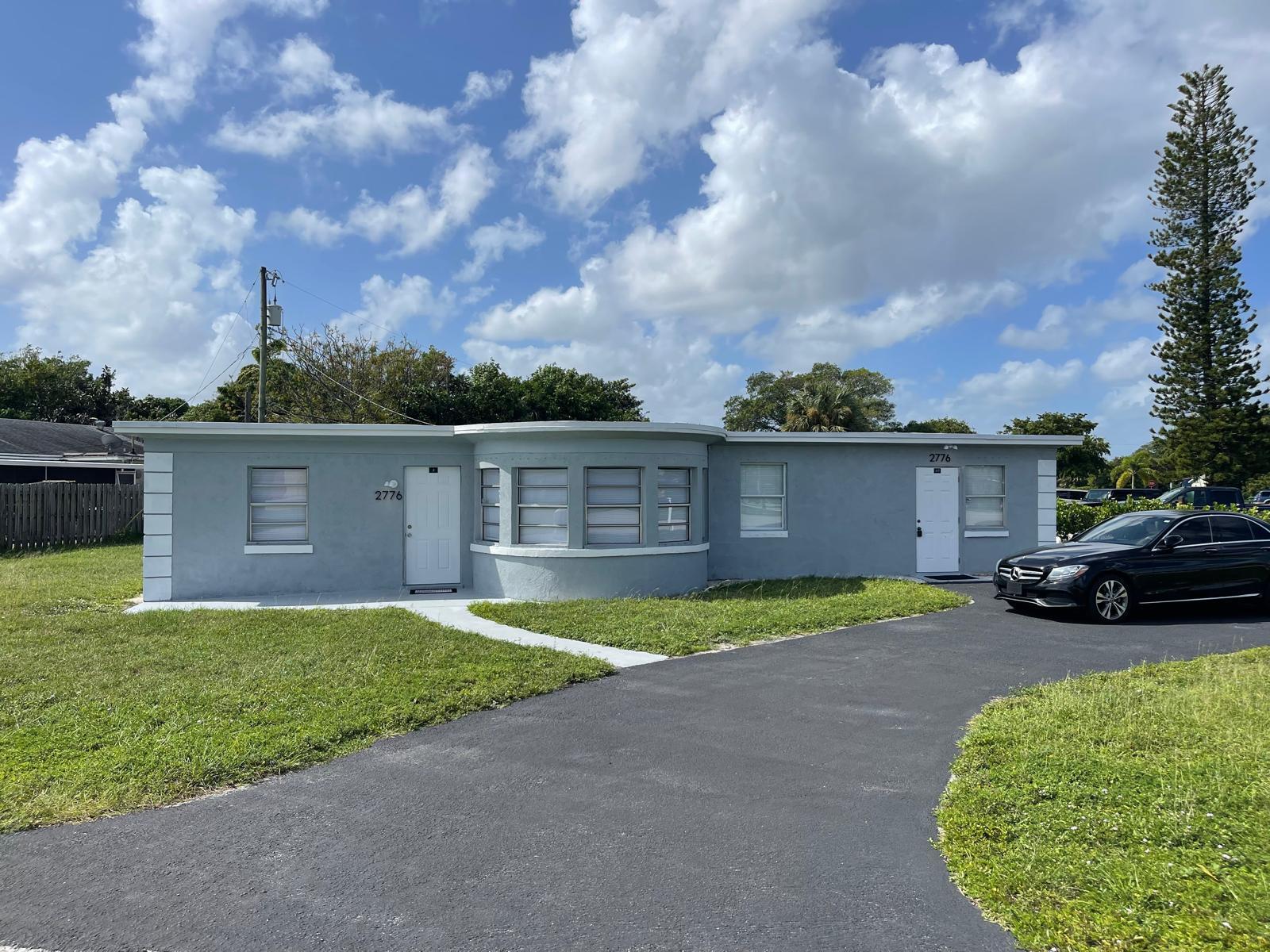 2776 Seminole Road Palm Springs, FL 33406 - Photo 3 of 24 a view of a yard with a house