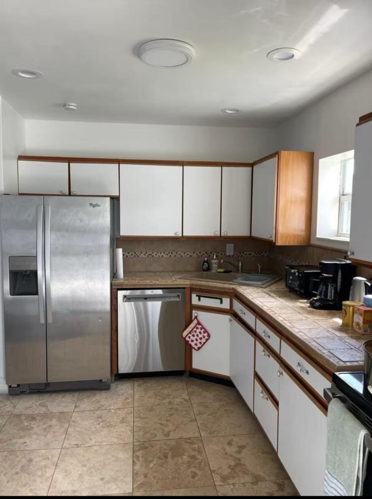 2776 Seminole Road Palm Springs, FL 33406 - Photo 8 of 24 a kitchen with stainless steel appliances granite countertop a sink a stove and a refrigerator
