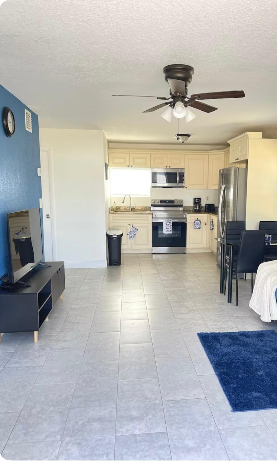 2776 Seminole Road Palm Springs, FL 33406 - Photo 10 of 24 a living room with furniture and a chandelier