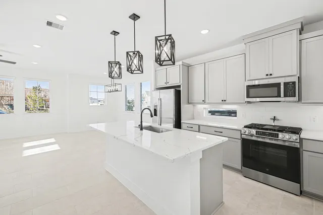 a view of a kitchen with furniture and a ceiling fan