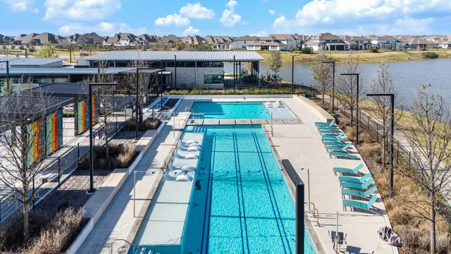 an aerial view of a house with outdoor space and lake view